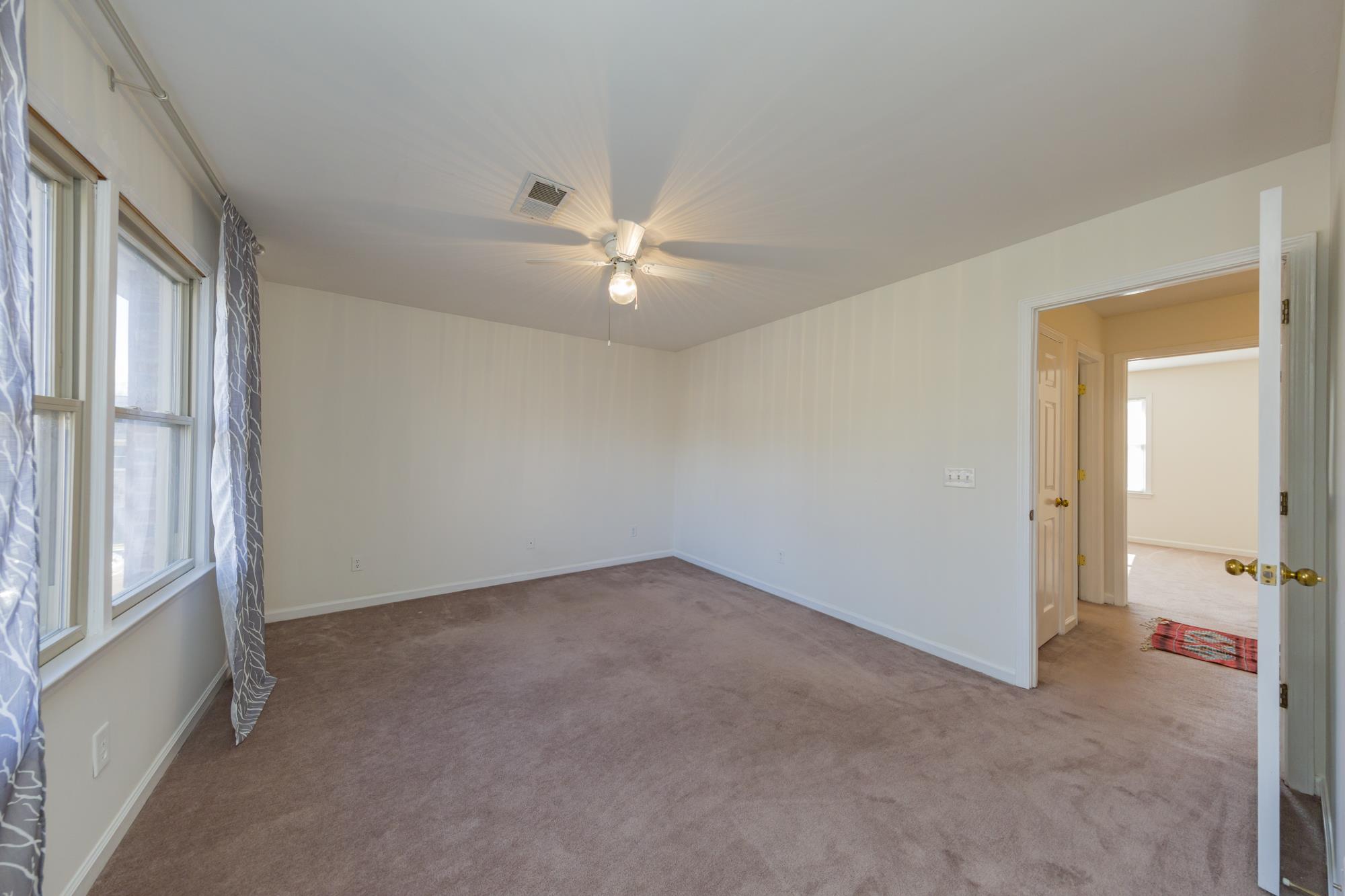 765 Kent Road, Unit 765 Nashville, TN 37214 - Photo 20 of 30 an empty room with chandelier fan and windows