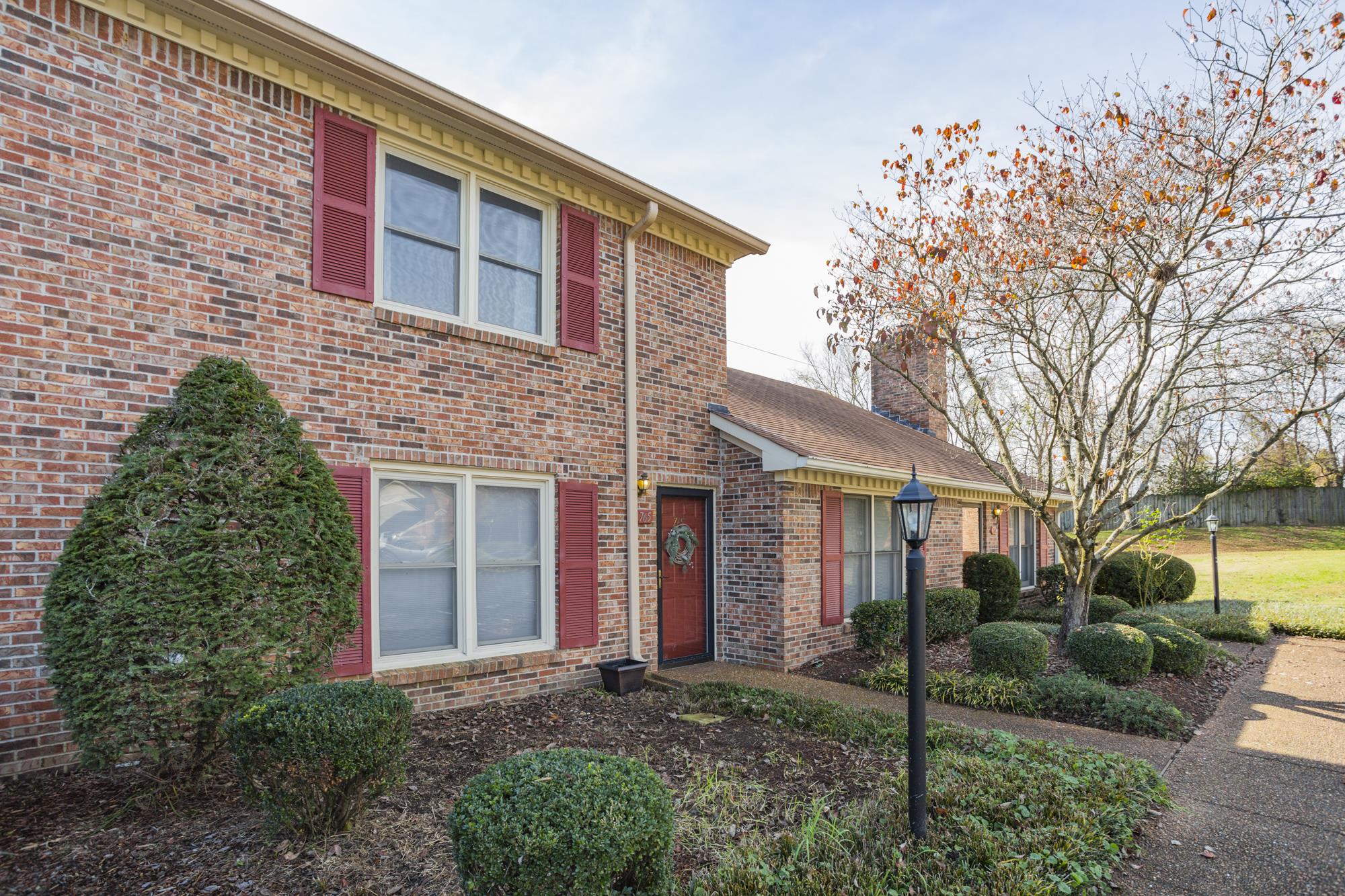 765 Kent Road, Unit 765 Nashville, TN 37214 - Photo 30 of 30 a view of a brick house with a yard and large tree