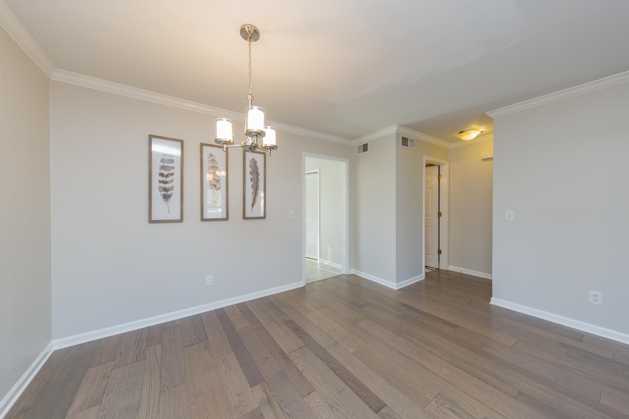 765 Kent Road, Unit 765 Nashville, TN 37214 - Photo 8 of 30 a view of a room with wooden floor and chandelier