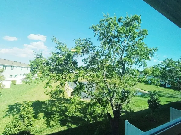 a view of a kitchen with sink and refrigerator