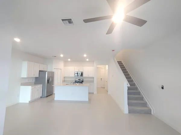 a kitchen that has a sink a stove and a refrigerator