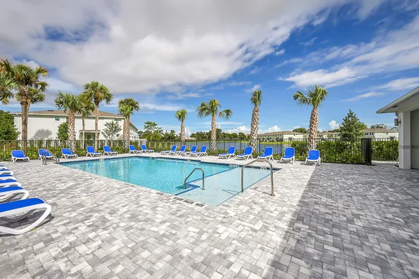 a view of swimming pool with outdoor seating and city view