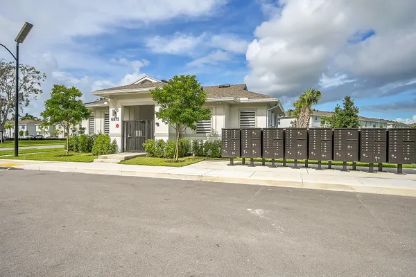 a view of a house with a yard in front of it