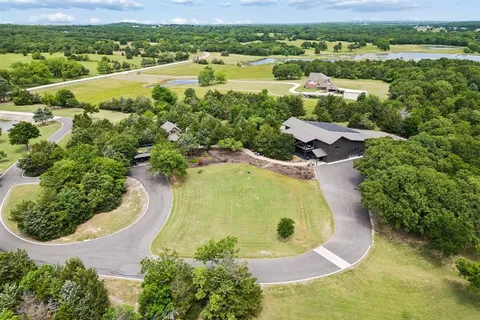 an aerial view of residential houses with outdoor space and swimming pool