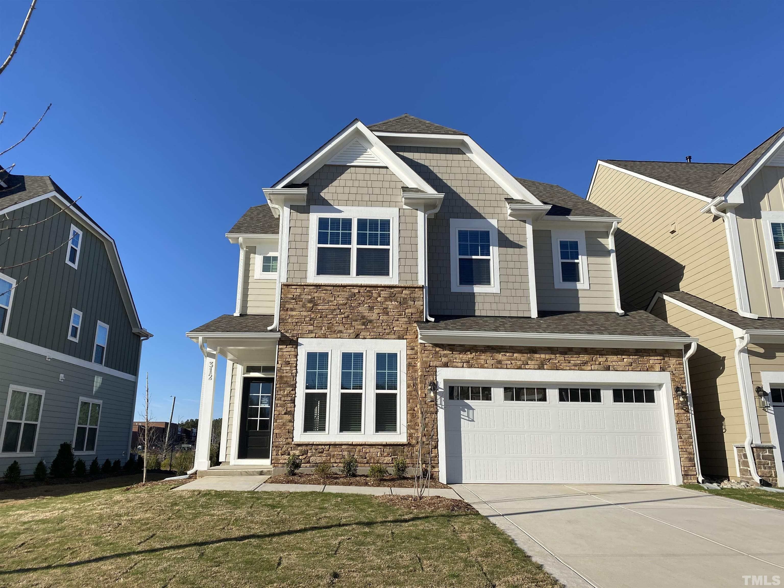 312 Ressler Street, Unit 504 Holly Springs, NC 27540 - Photo 1 of 30 a front view of a house with a yard