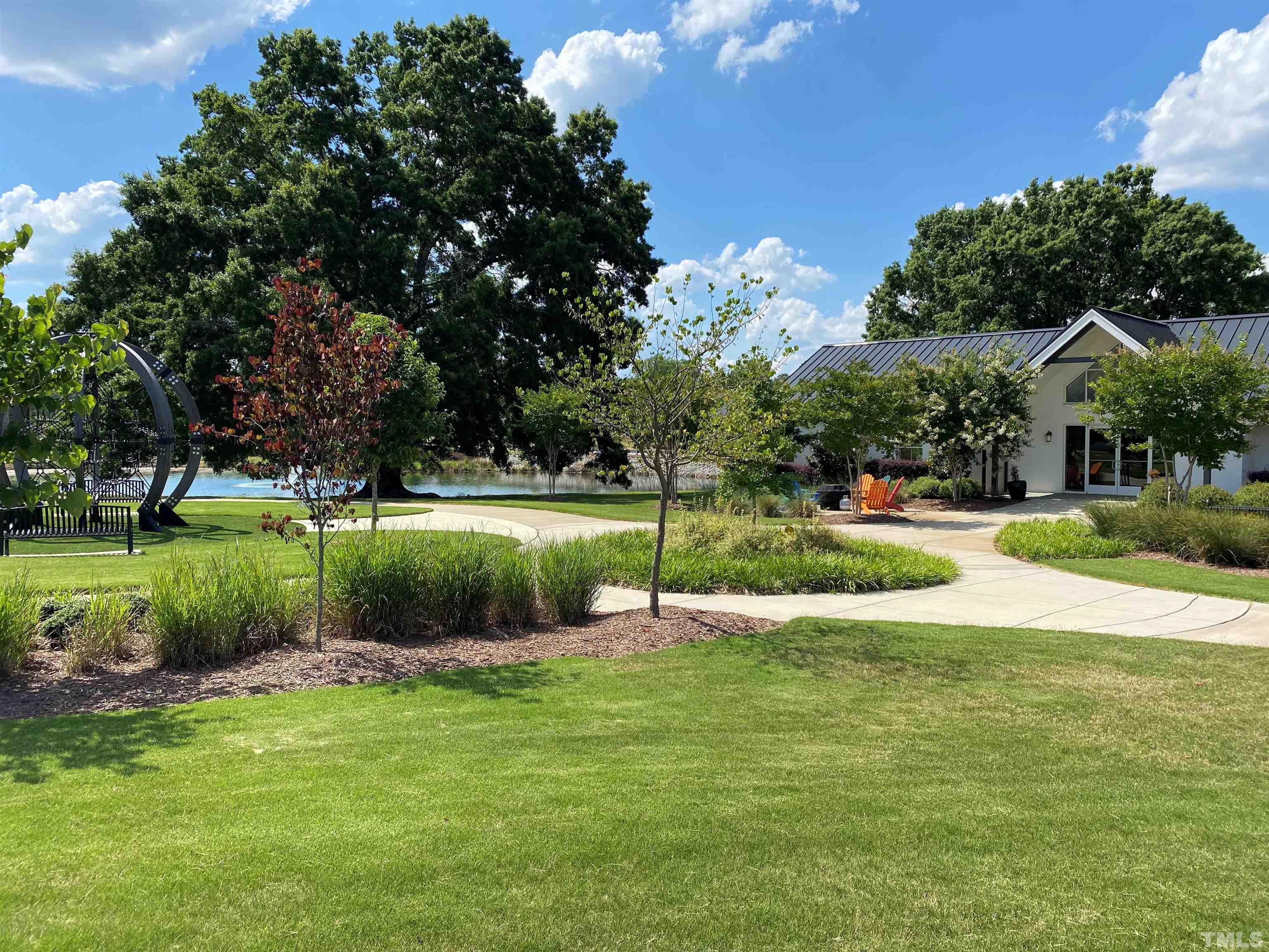 312 Ressler Street, Unit 504 Holly Springs, NC 27540 - Photo 27 of 30 a view of a golf course with a lake view