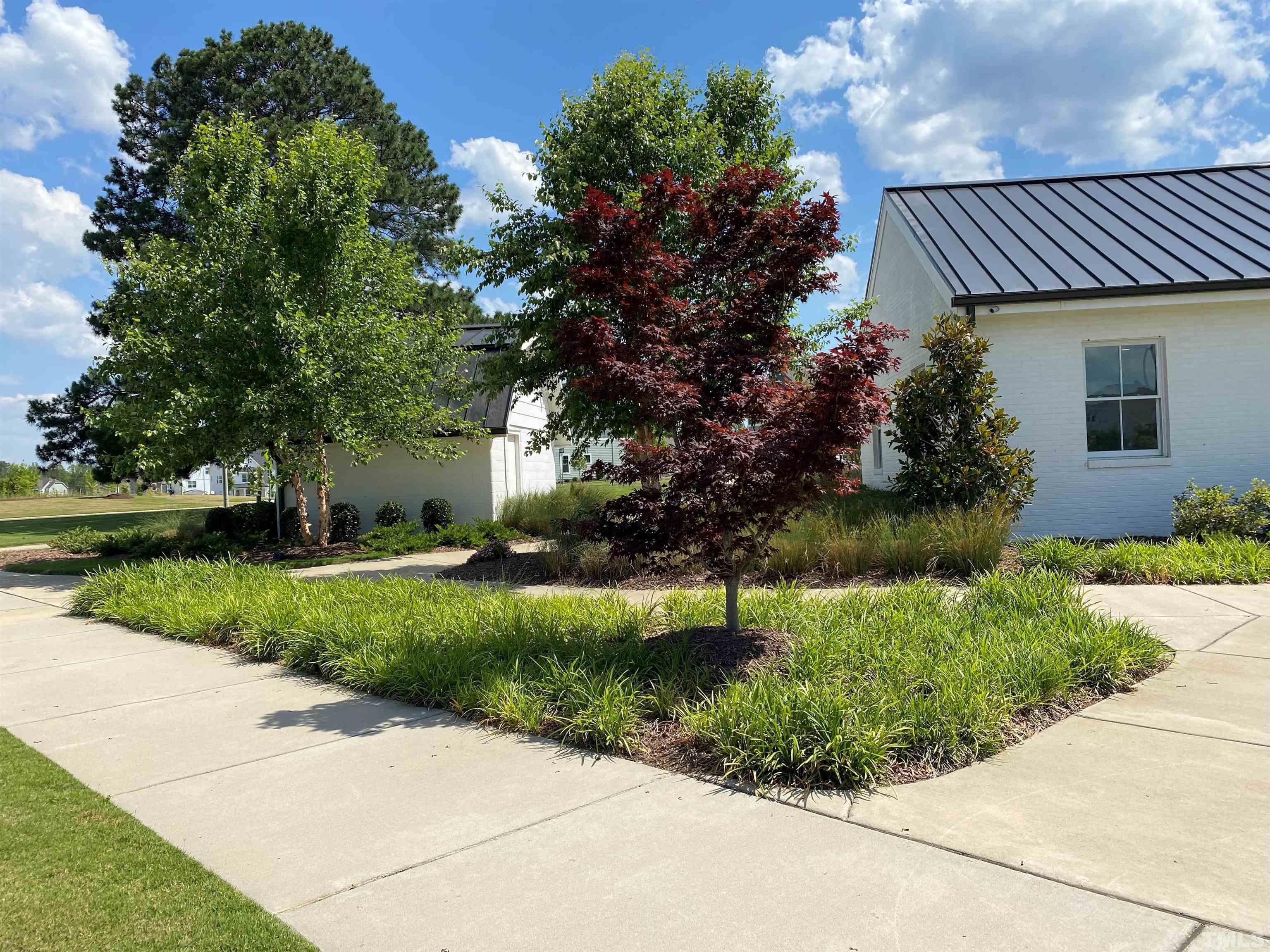 312 Ressler Street, Unit 504 Holly Springs, NC 27540 - Photo 30 of 30 a front view of a house with garden