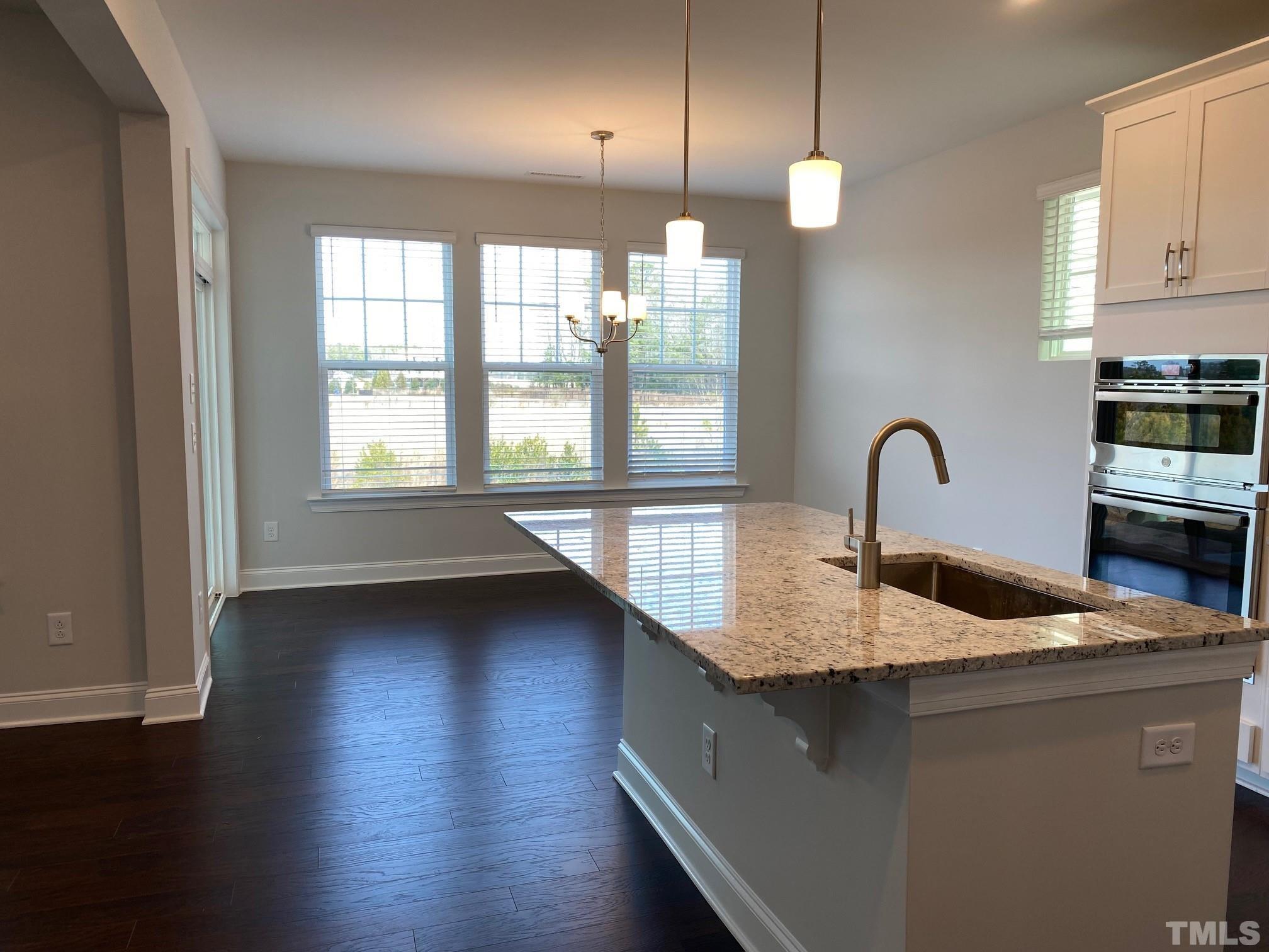 312 Ressler Street, Unit 504 Holly Springs, NC 27540 - Photo 7 of 30 a kitchen with sink and cabinets
