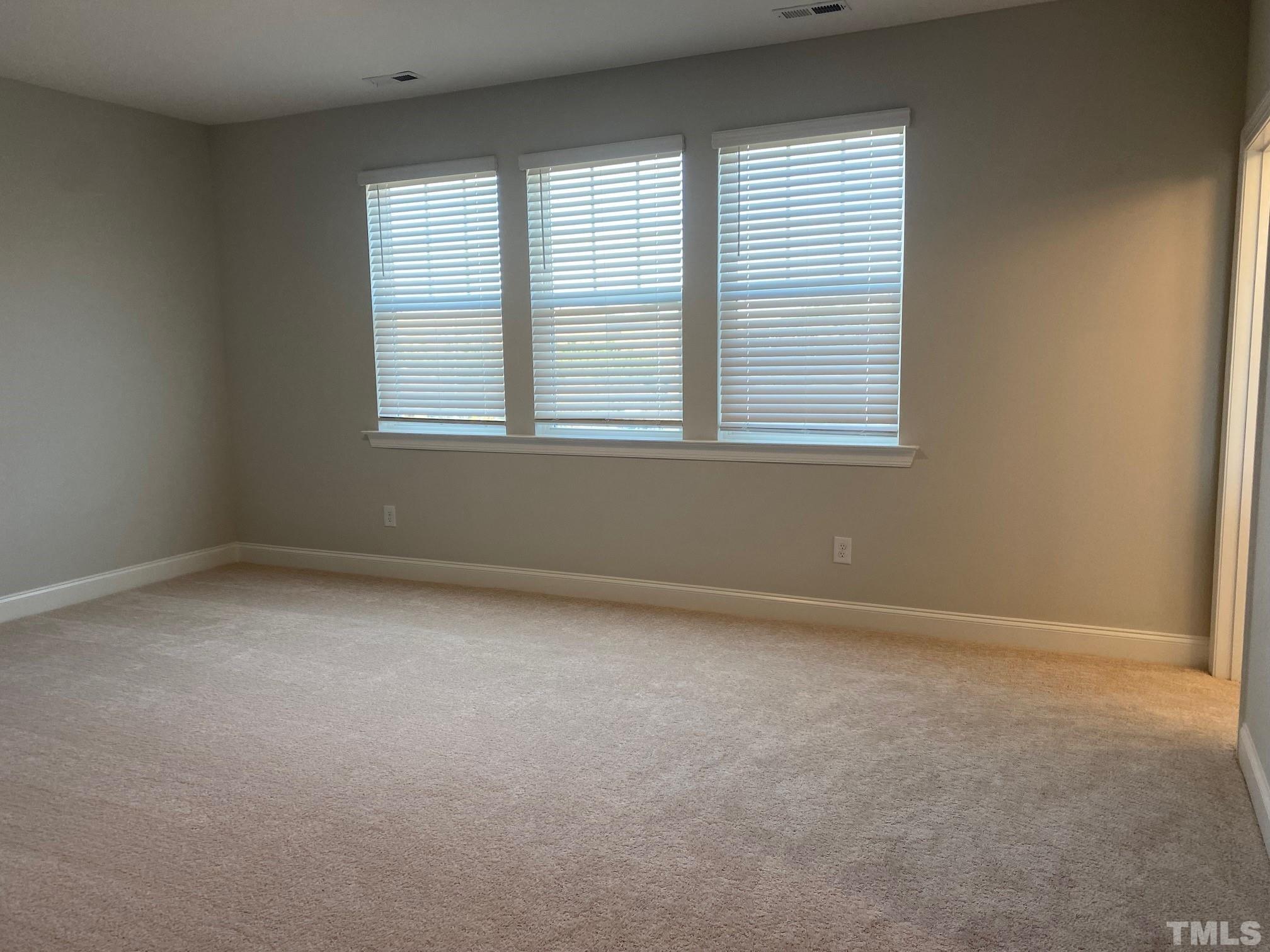 312 Ressler Street, Unit 504 Holly Springs, NC 27540 - Photo 9 of 30 an empty room with a window