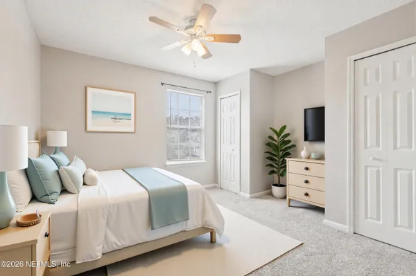 a bedroom with a large bed and a window