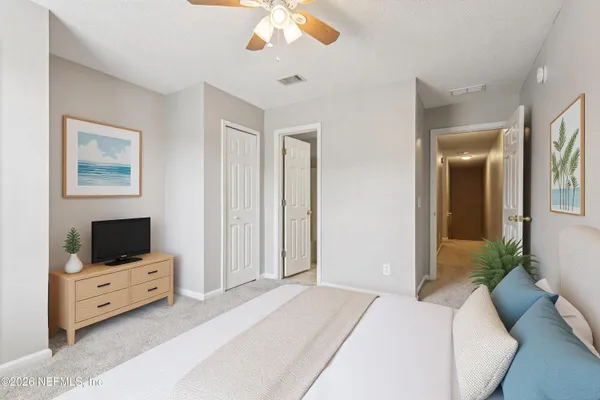 a bedroom with a bed and a flat screen tv