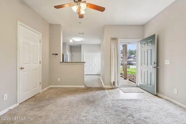 an empty room with closet and windows