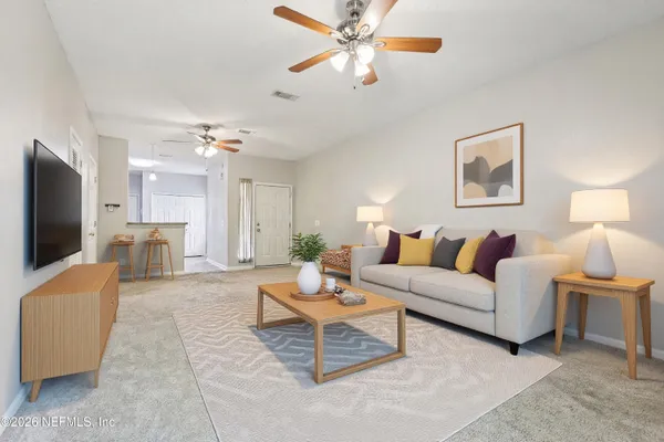 a living room with furniture and a flat screen tv