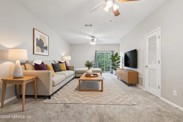 a living room with furniture and a flat screen tv