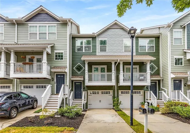 a front view of a residential apartment building with a yard