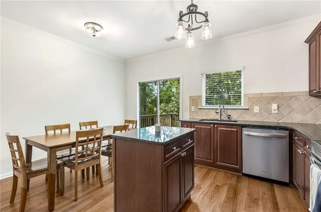 a kitchen with stainless steel appliances granite countertop a sink a stove microwave and cabinets