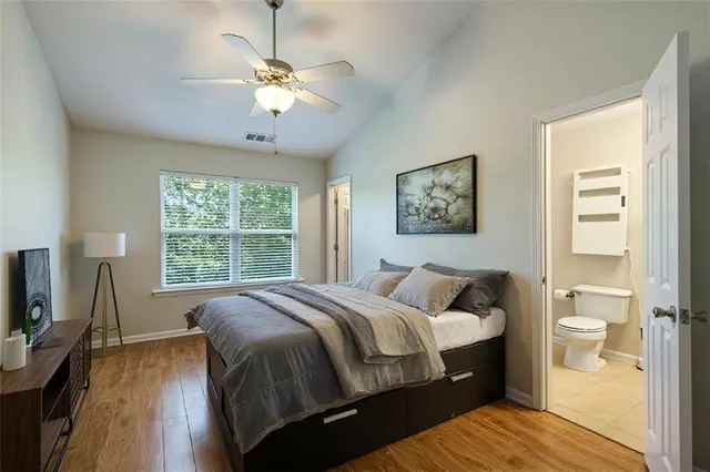 a bed sitting in a bedroom next to a window