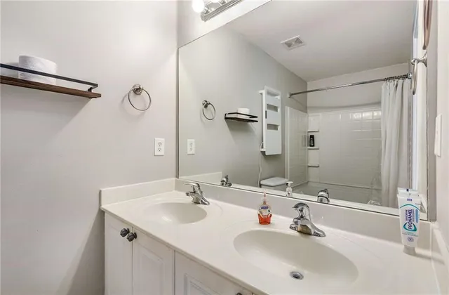 a bathroom with a tub shower and a sink