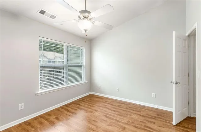 a bedroom with a bed a dresser and a window