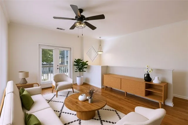 a living room with furniture and a wooden floor