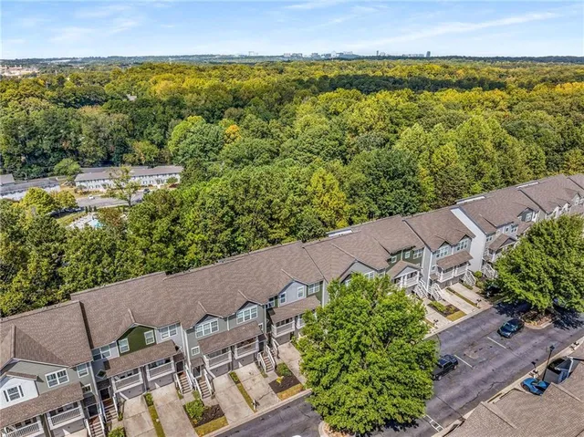 an aerial view of a house with a yard and lake view