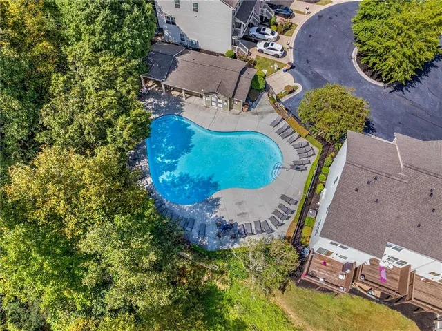 a view of a house with swimming pool and a small yard