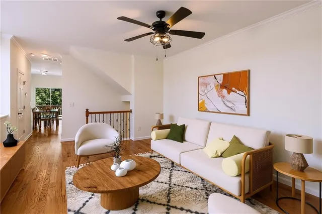 a living room with furniture a rug and a chandelier
