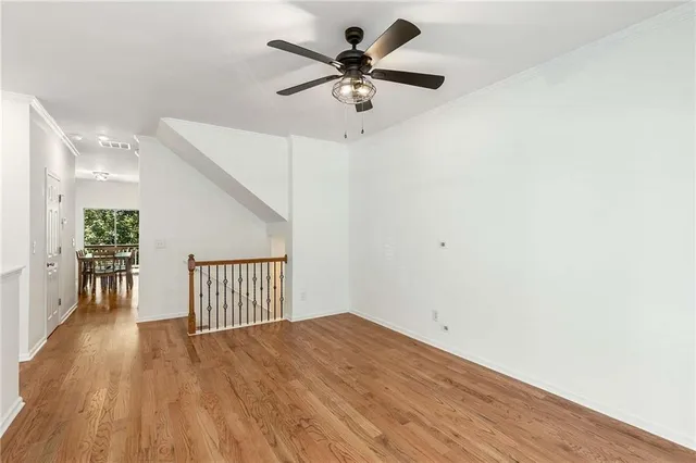 a view of an empty room with wooden floor