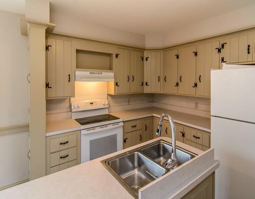 53 Burbank Road Sutton, MA 01590 - Photo 9 of 29 a kitchen with white cabinets and white appliances