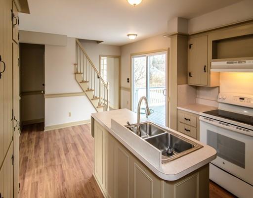 53 Burbank Road Sutton, MA 01590 - Photo 10 of 29 a kitchen that has a sink a stove and a wooden floor