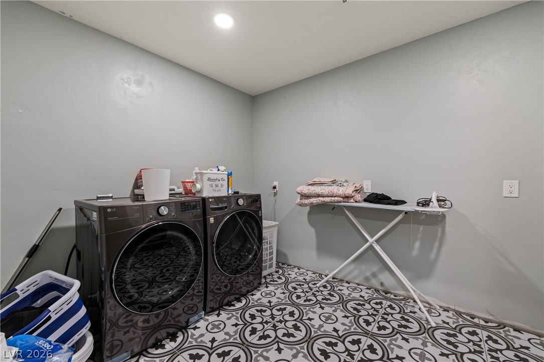 750 Leming Avenue Overton, NV 89040 - Photo 44 of 82 This dedicated laundry space combines modern appliances with unique patterned flooring for a refreshing aesthetic.