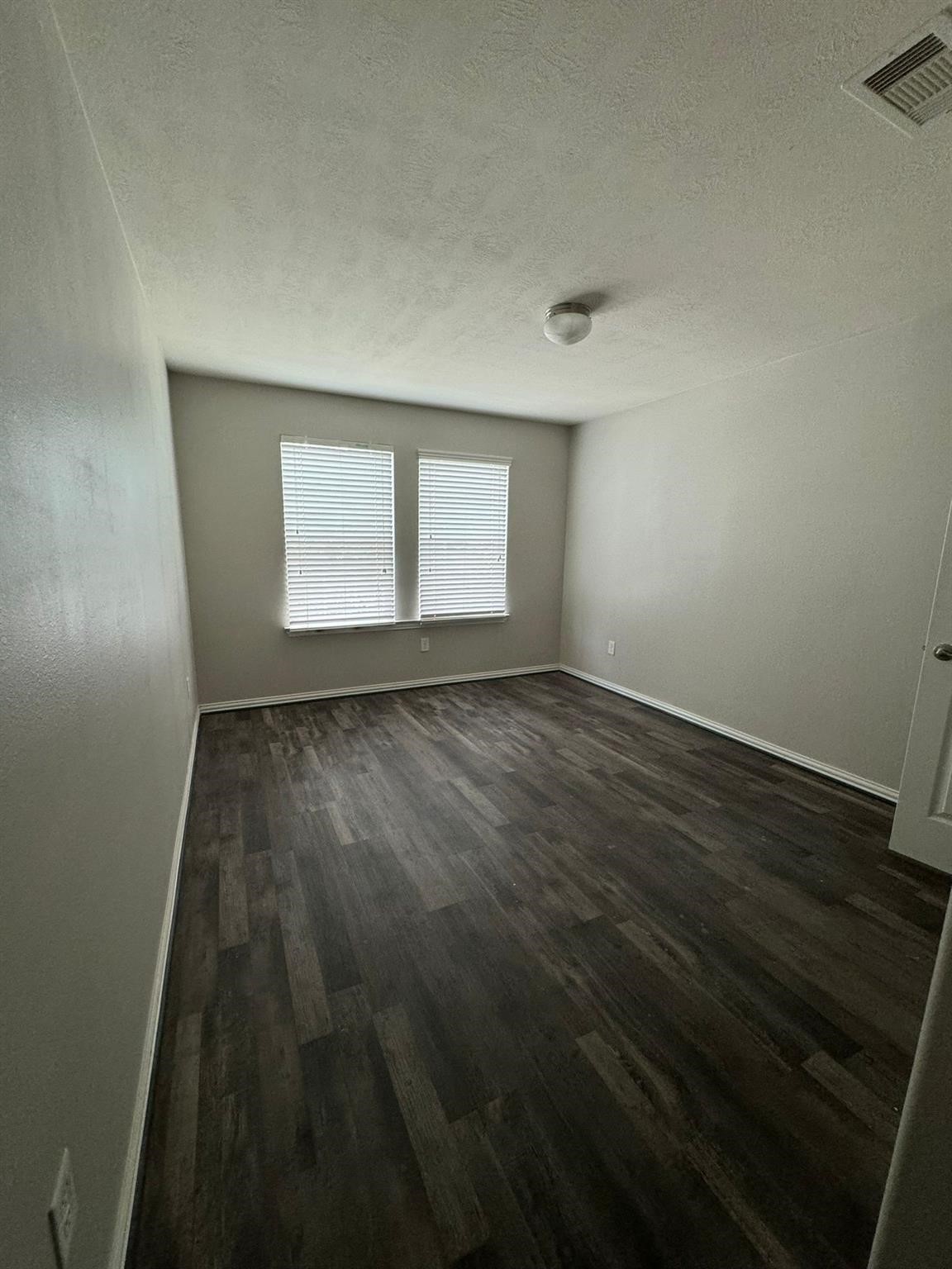 25614 Crisp Spring Lane Spring, TX 77373 - Photo 15 of 25 an empty room with wooden floor and windows