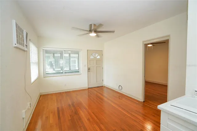 wooden floor in an empty room with a window
