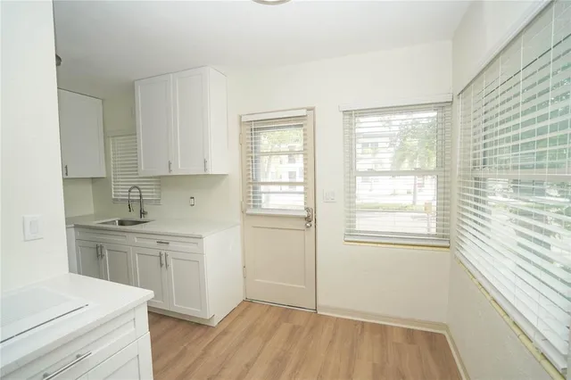 a view of a kitchen with a sink cabinets and wooden floor