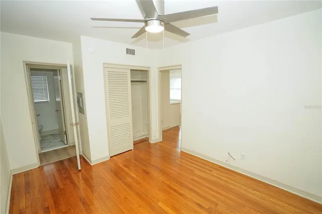 a view of empty room with wooden floor