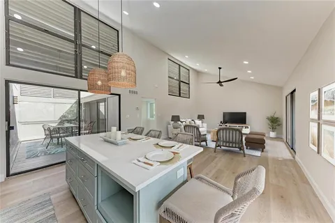 a bathroom with a granite countertop sink a toilet and shower