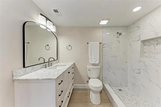 a bathroom with a sink toilet and shower