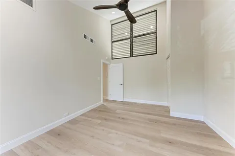 a view of a swimming pool with a table and chairs under an umbrella