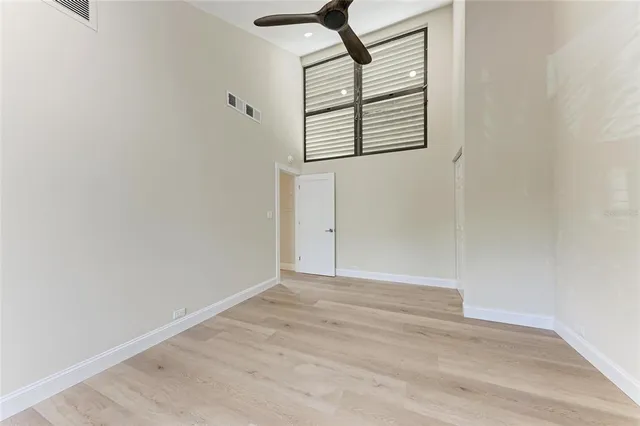 a view of a swimming pool with a table and chairs under an umbrella