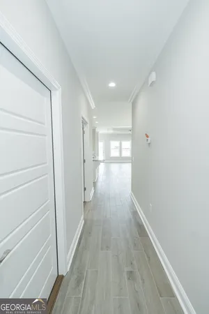 a view of hallway with wooden floor