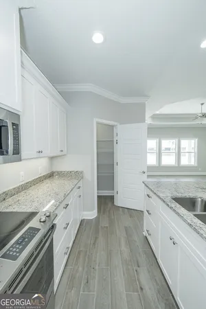 a kitchen with granite countertop a sink and a stove top oven