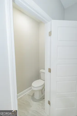 a white toilet sitting next to a shower