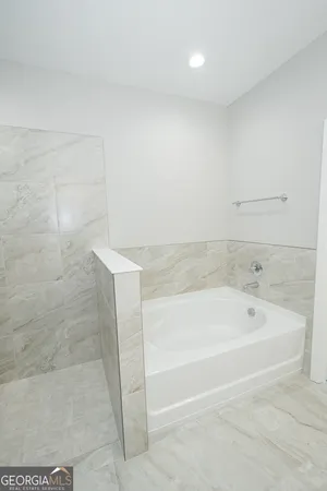 a spacious bathroom with a bathtub and shower