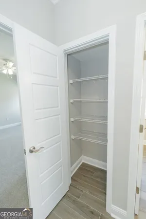 a view of walk in closet with empty racks