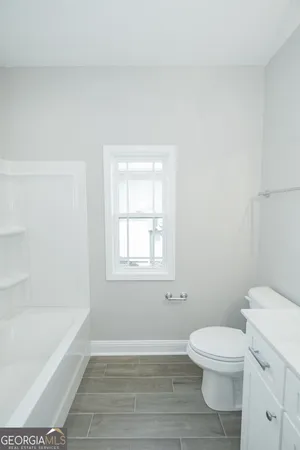 a bathroom with a toilet a sink and bathtub
