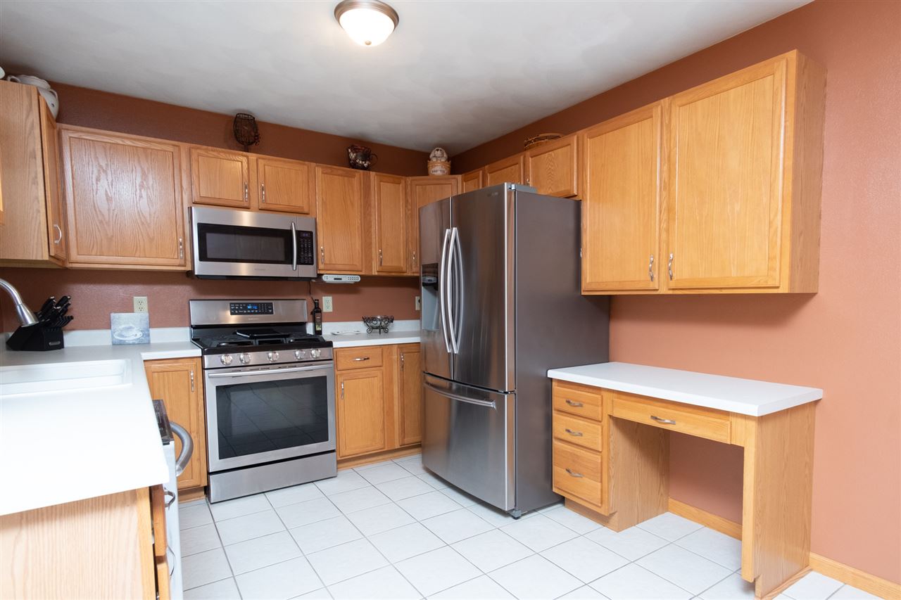682 Bayfield Road Rockton, IL 61072 - Photo 8 of 23 a kitchen with stainless steel appliances granite countertop a refrigerator sink and stove