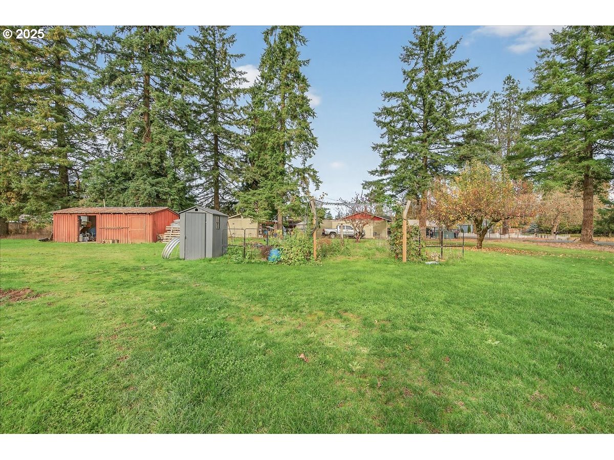 57827 South Bachelor Flat Road Warren, OR 97053 - Photo 11 of 38 a backyard of a house with table and chairs