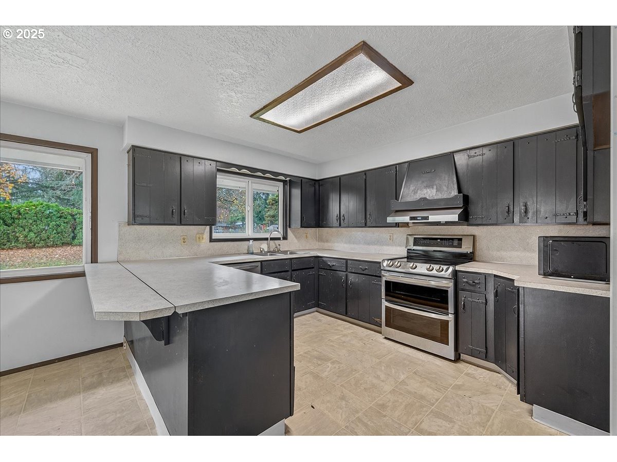 57827 South Bachelor Flat Road Warren, OR 97053 - Photo 20 of 38 a kitchen with kitchen island stainless steel appliances a sink stove and refrigerator