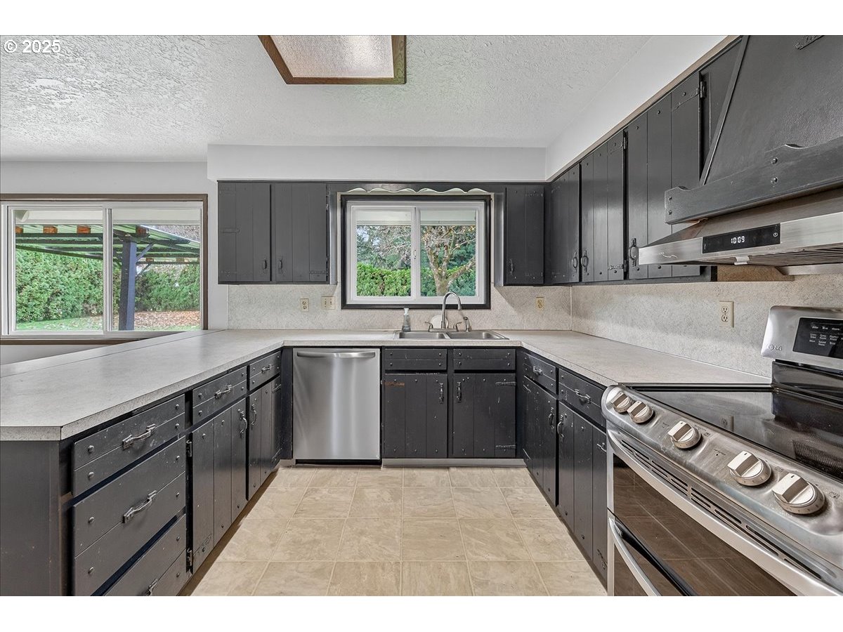 57827 South Bachelor Flat Road Warren, OR 97053 - Photo 21 of 38 a kitchen with a stove a sink and a window