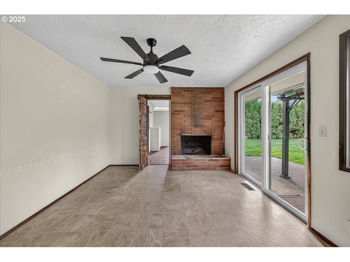 57827 South Bachelor Flat Road Warren, OR 97053 - Photo 24 of 38 a view of an empty room with a fireplace and a window